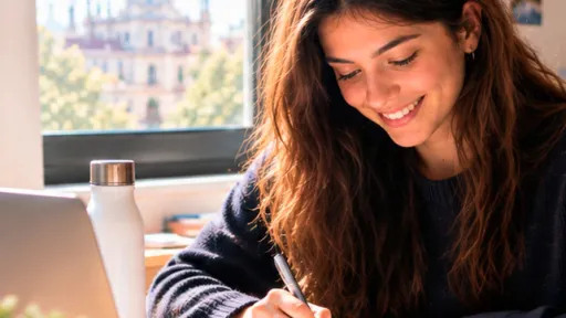 Hàbits d'estudi pel curs 26-27. Noia somrient estudiant amb vistes de Madrid per la finestra