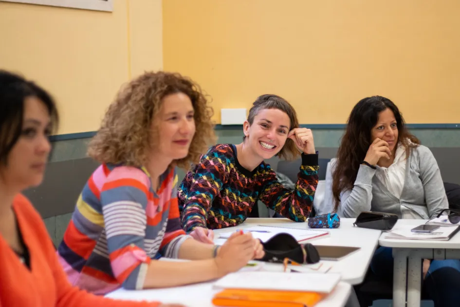 Estudiants somrients a un aula d'una facultat
